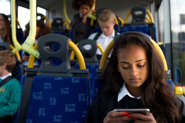 PIC - Teenager playing on phone on bus