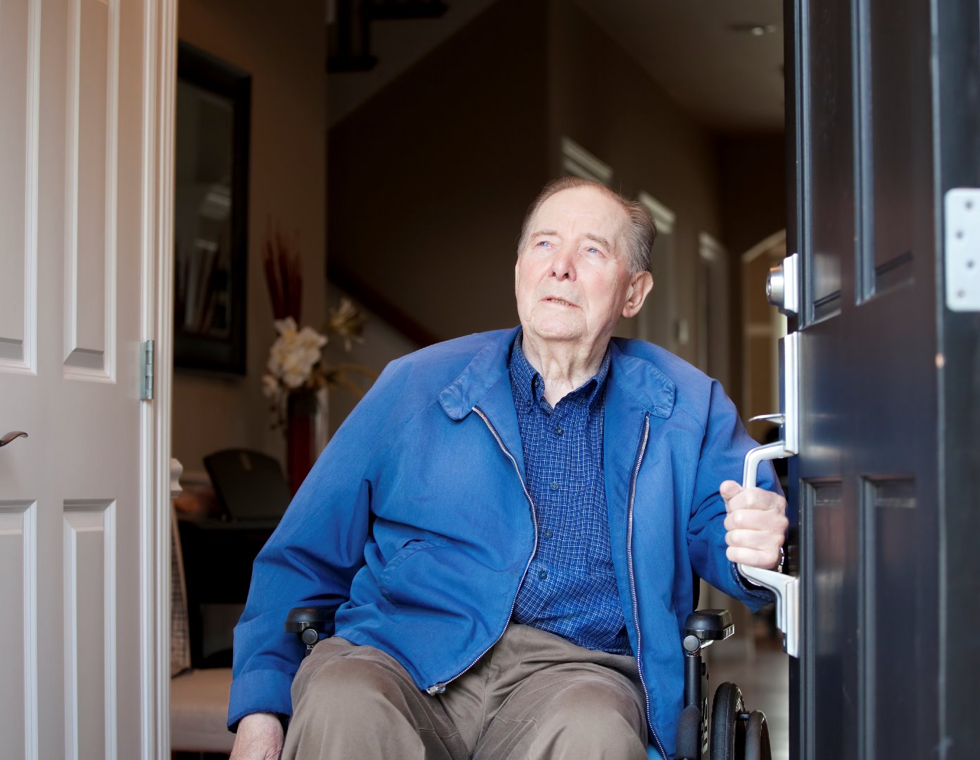 PIC - Older man in a doorway with a wheelchair