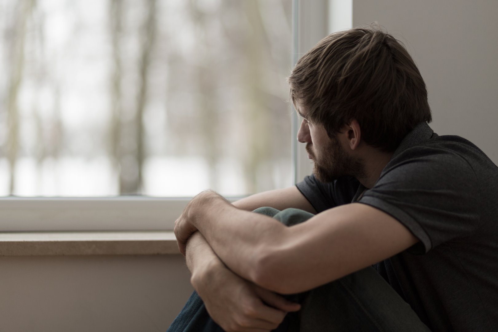 PIC - Sad man looking out of window