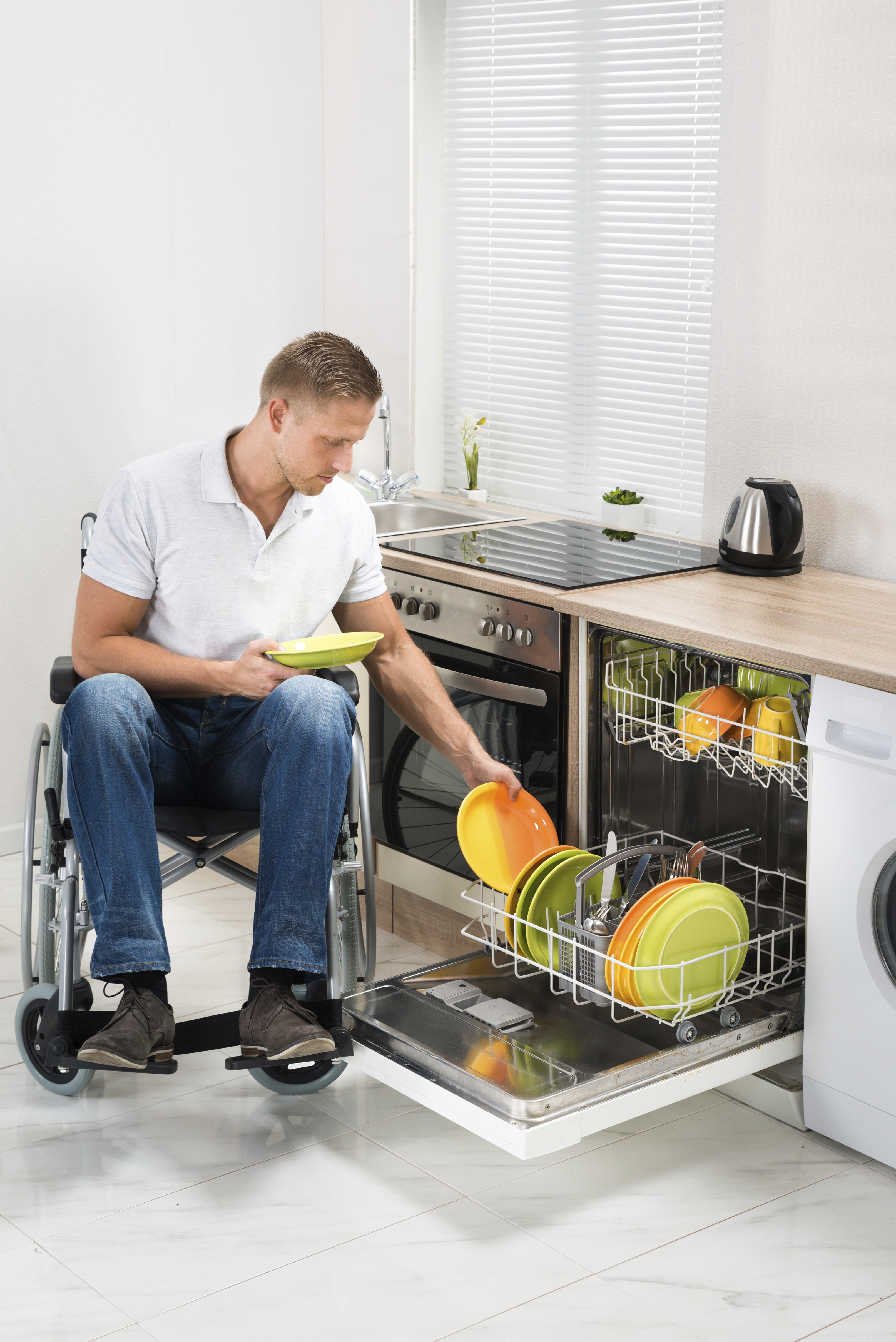 Younger wheelchair user in kitchen