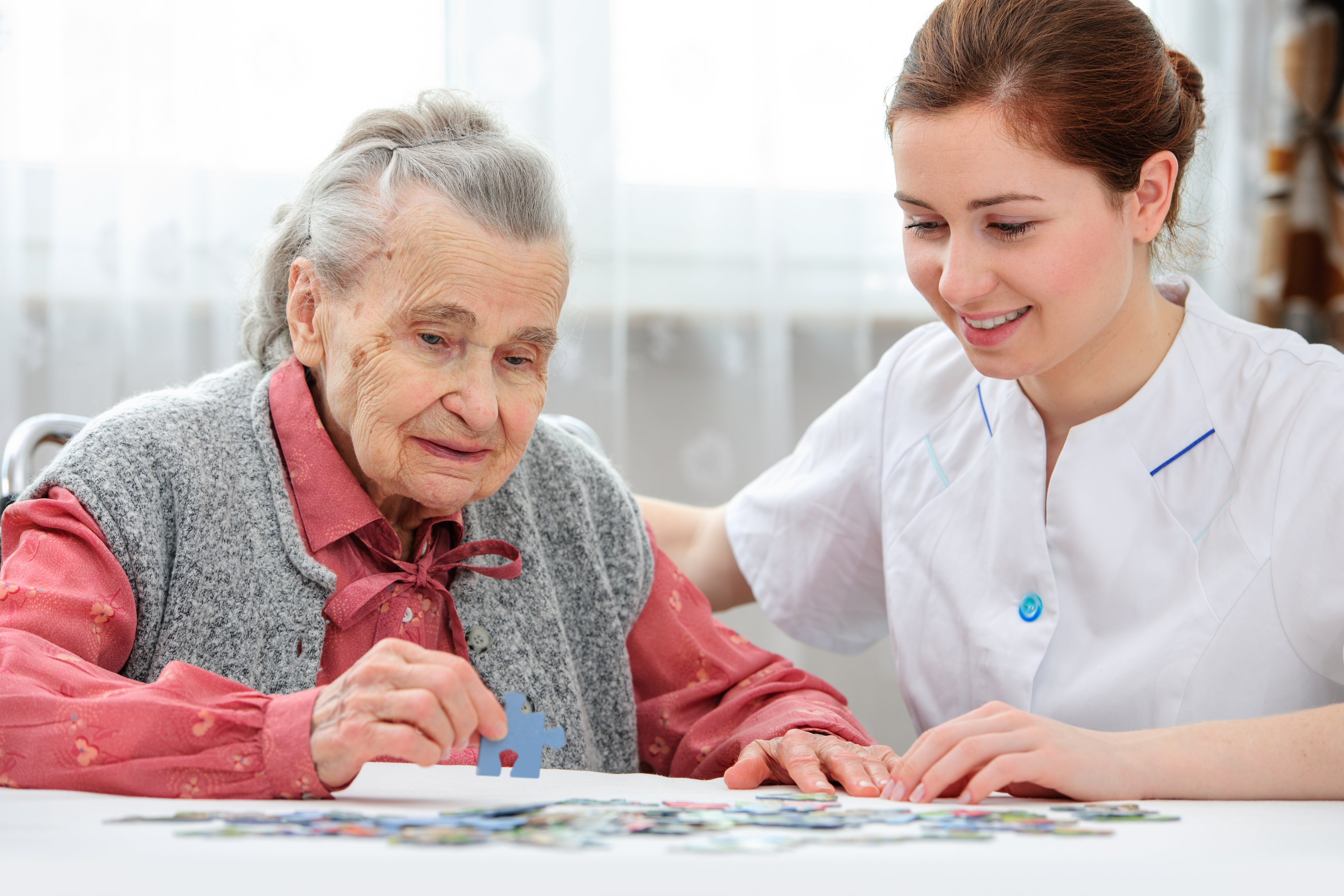 PIC - Older lady being helped with jigsaw