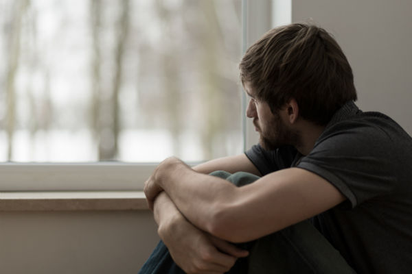 PIC - man looking sad and gazing out of a window