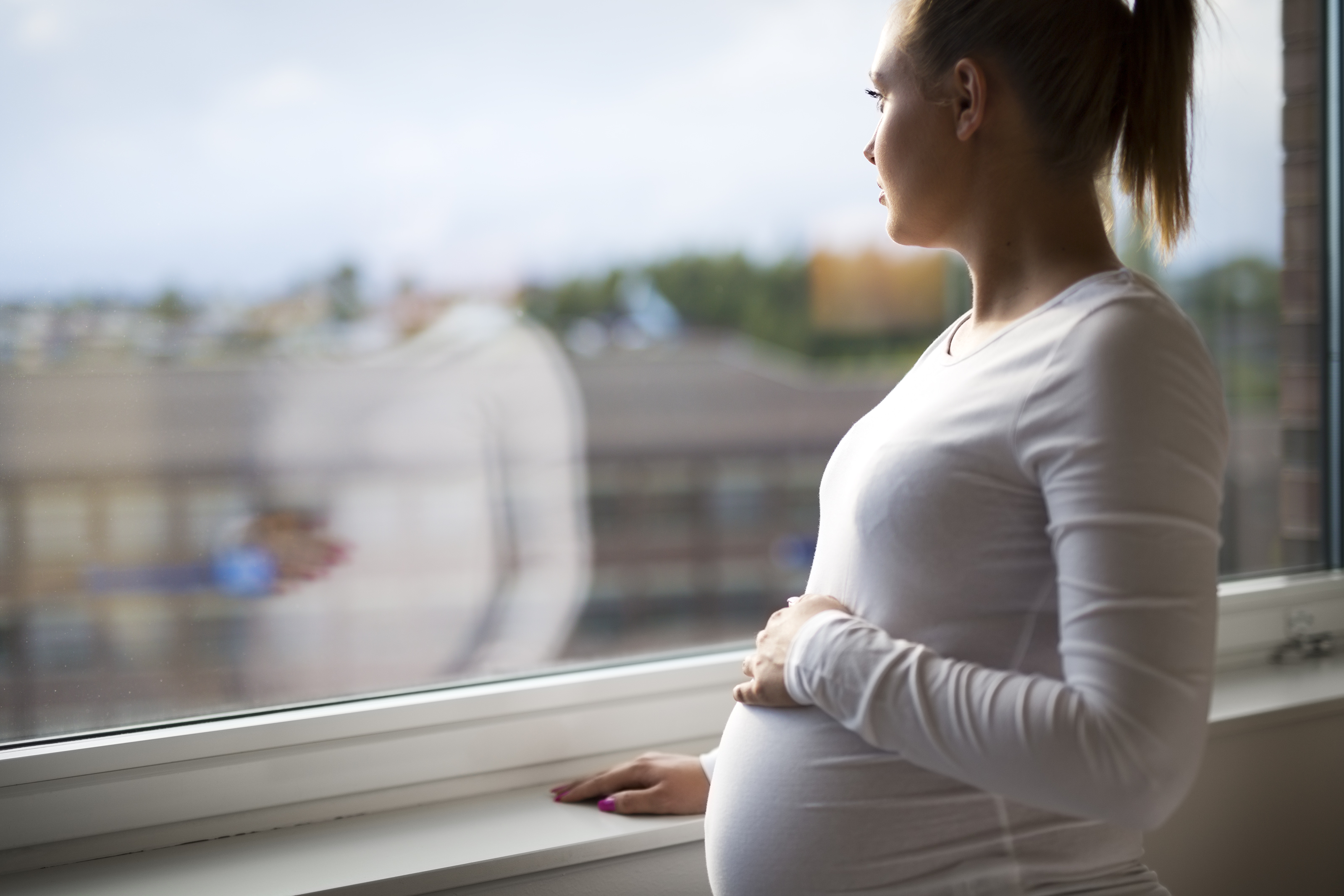 PIC - Pregnant woman by window