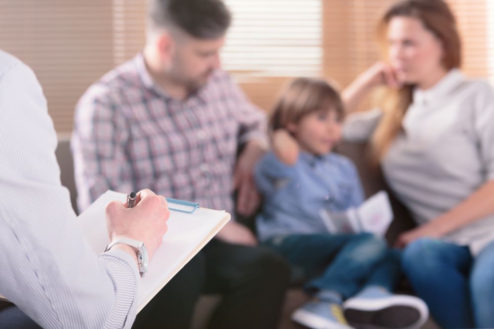 PIC - somebody talking to a family and taking notes