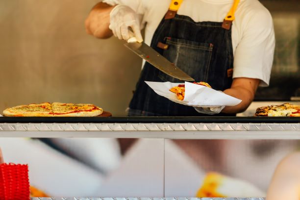 PIC - man serving pizza