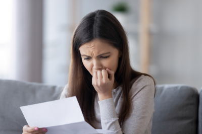 Woman reading a letter containing bad news