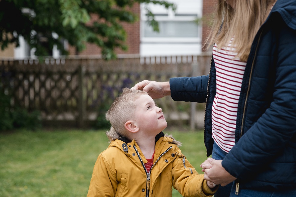 PIC - young boy looking up at adult