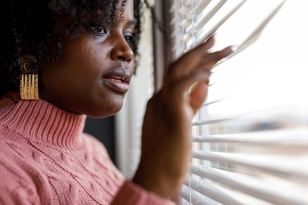 PIC - woman looking through blinds