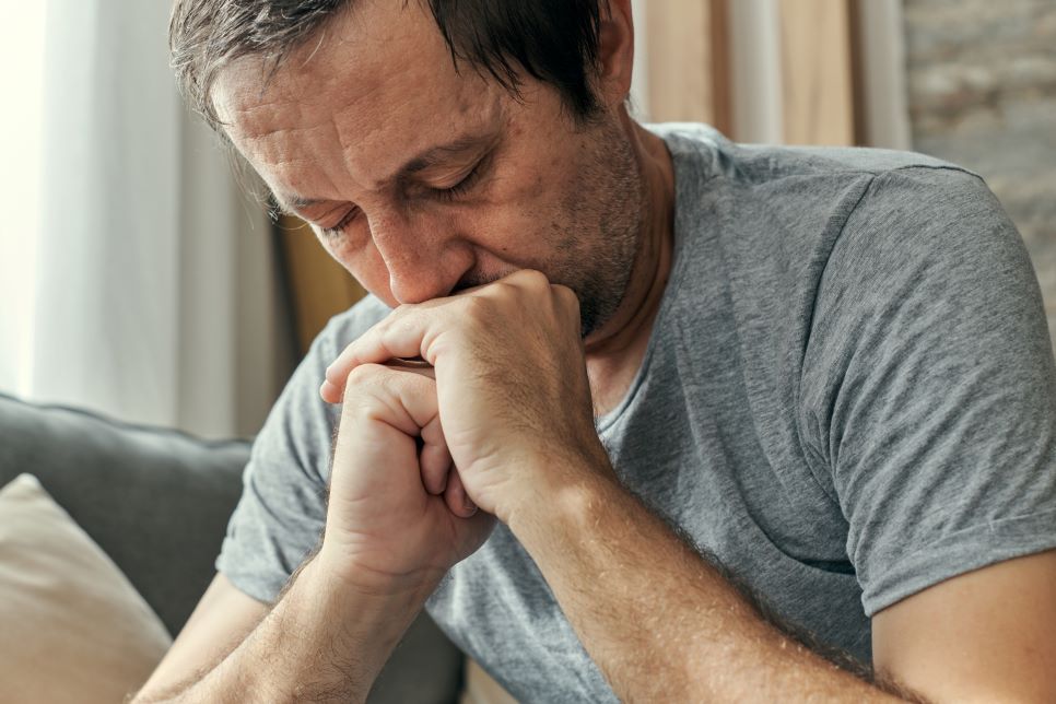 PIC - Anxious man on sofa